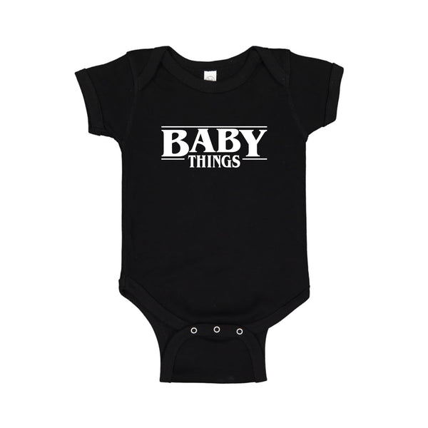 black onesie that says "baby things"