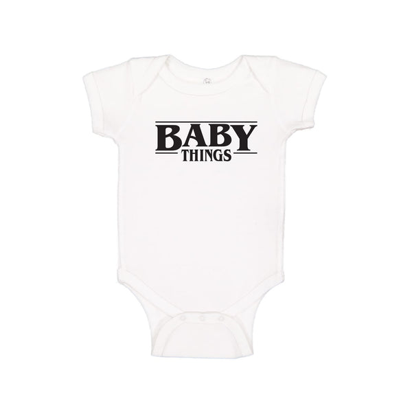 white onesie that says "baby things"
